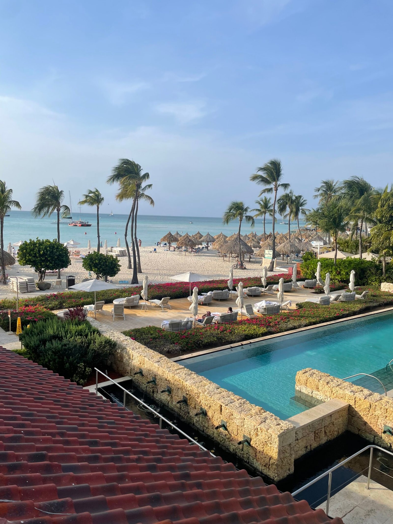 Oceanfront resort with pool, tropical landscaping and beach in Puerto Vallarta Mexico