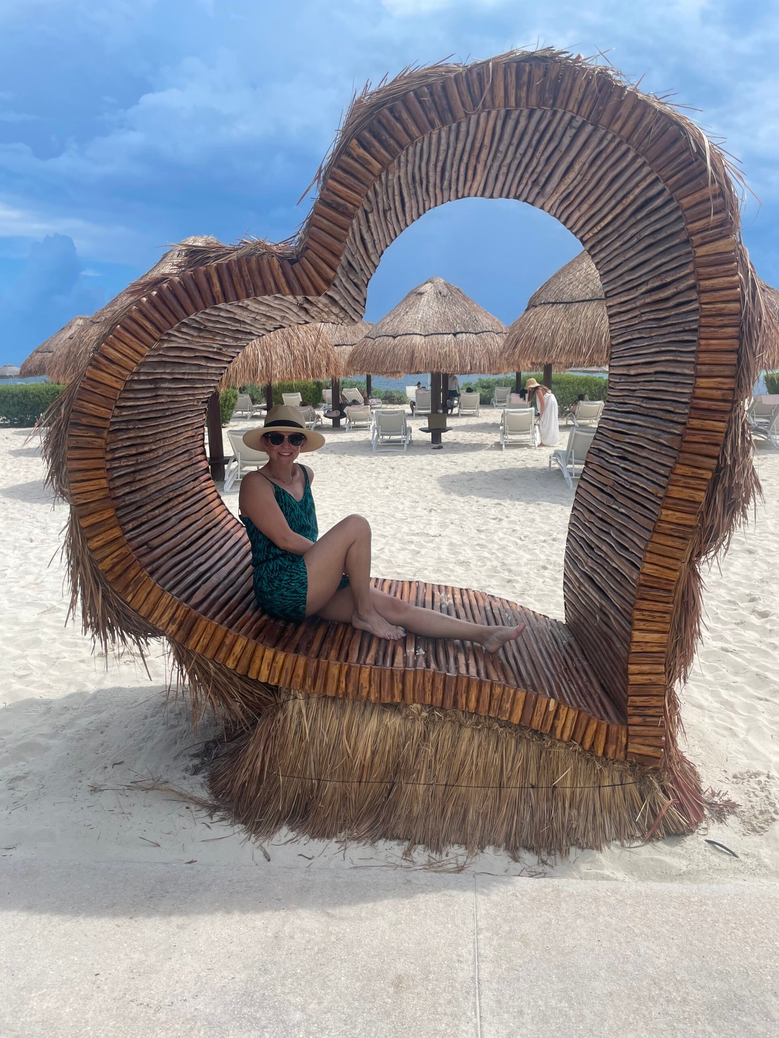 Traveler relaxing in a heart-shaped beach chair in Mexico